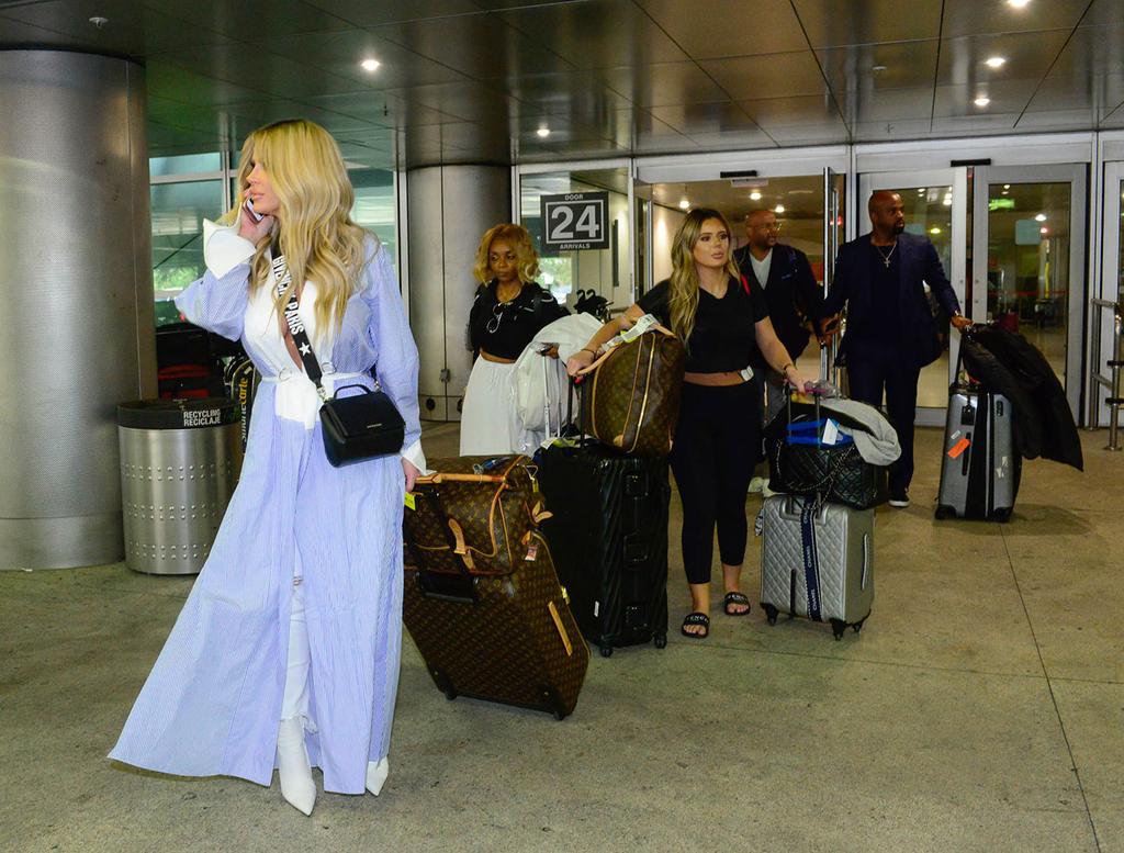 Kim Zolciak Flashes Boobs In Bizarre Robe Outfit At Airport