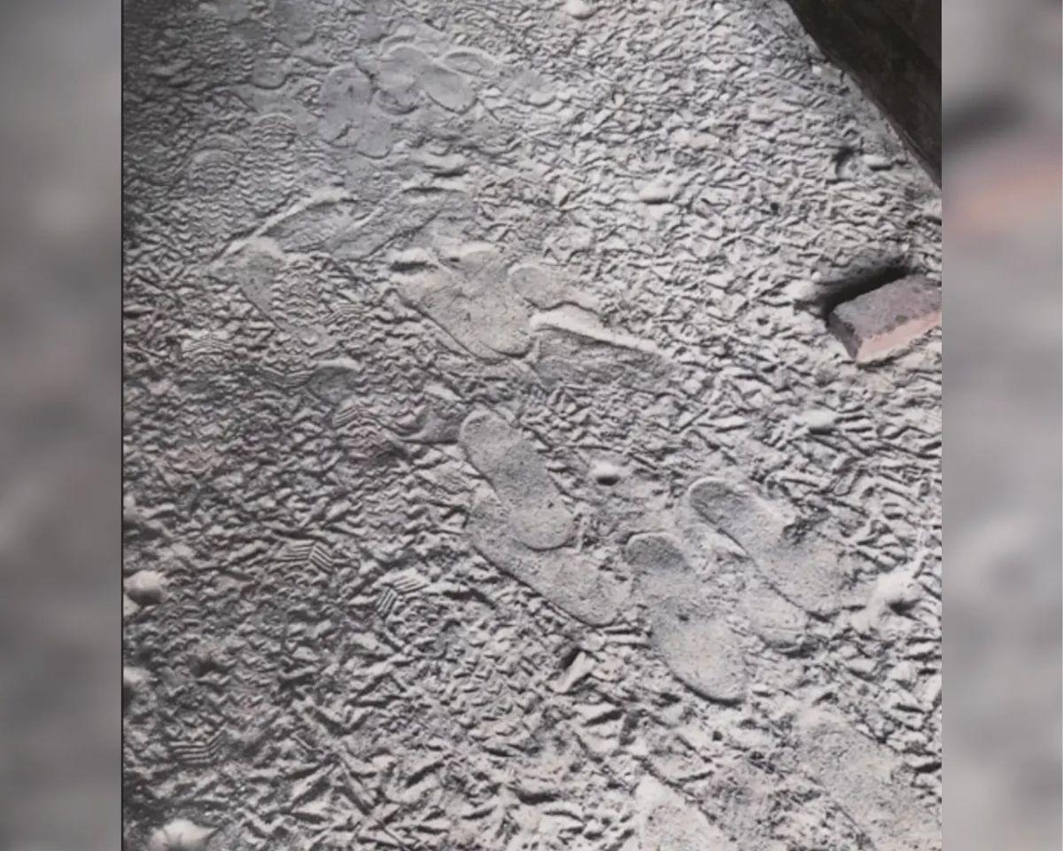 Sandal footprints in the dirt.