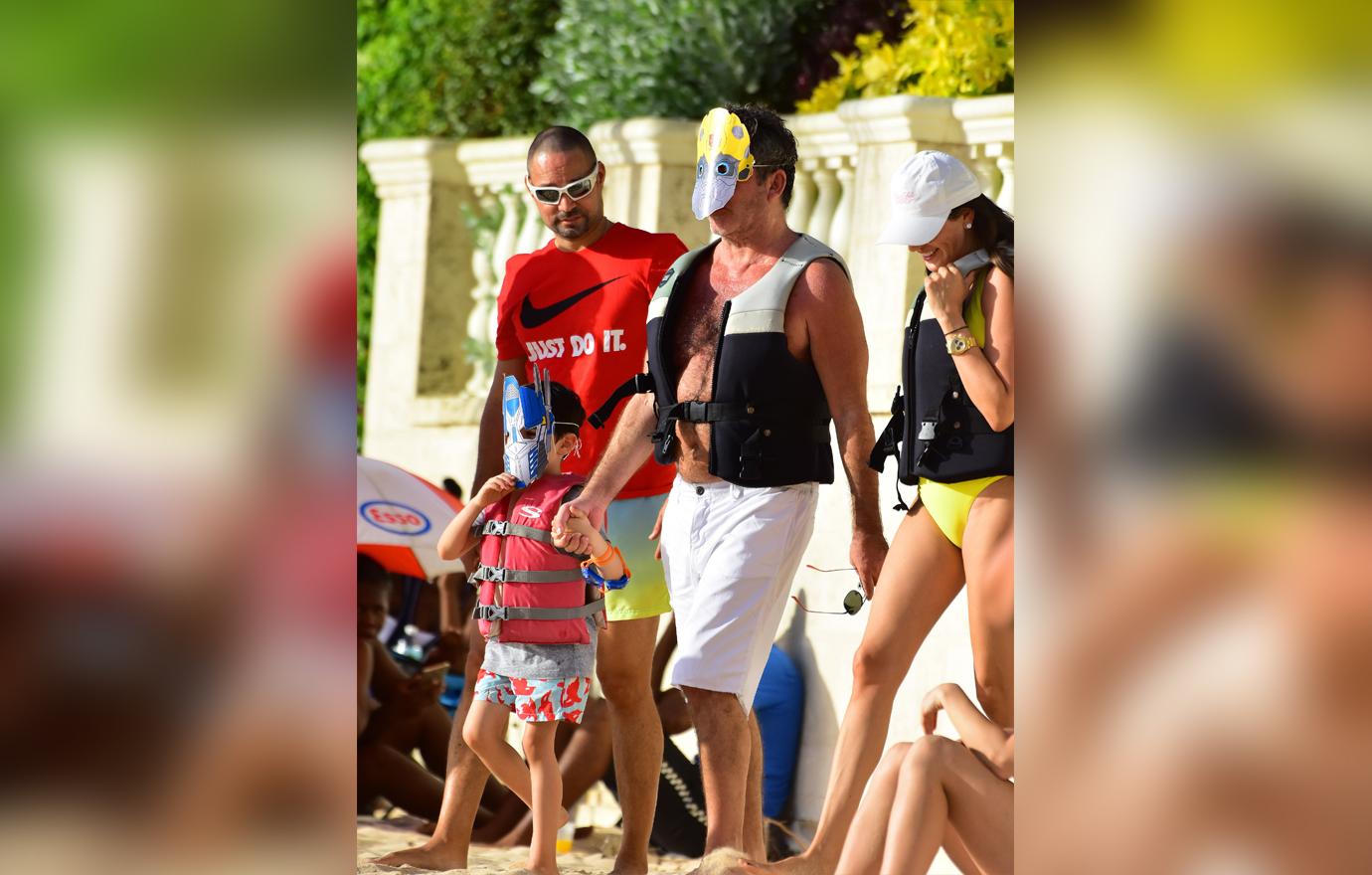 //simon cowell wears transformers mask on jet ski ride with son