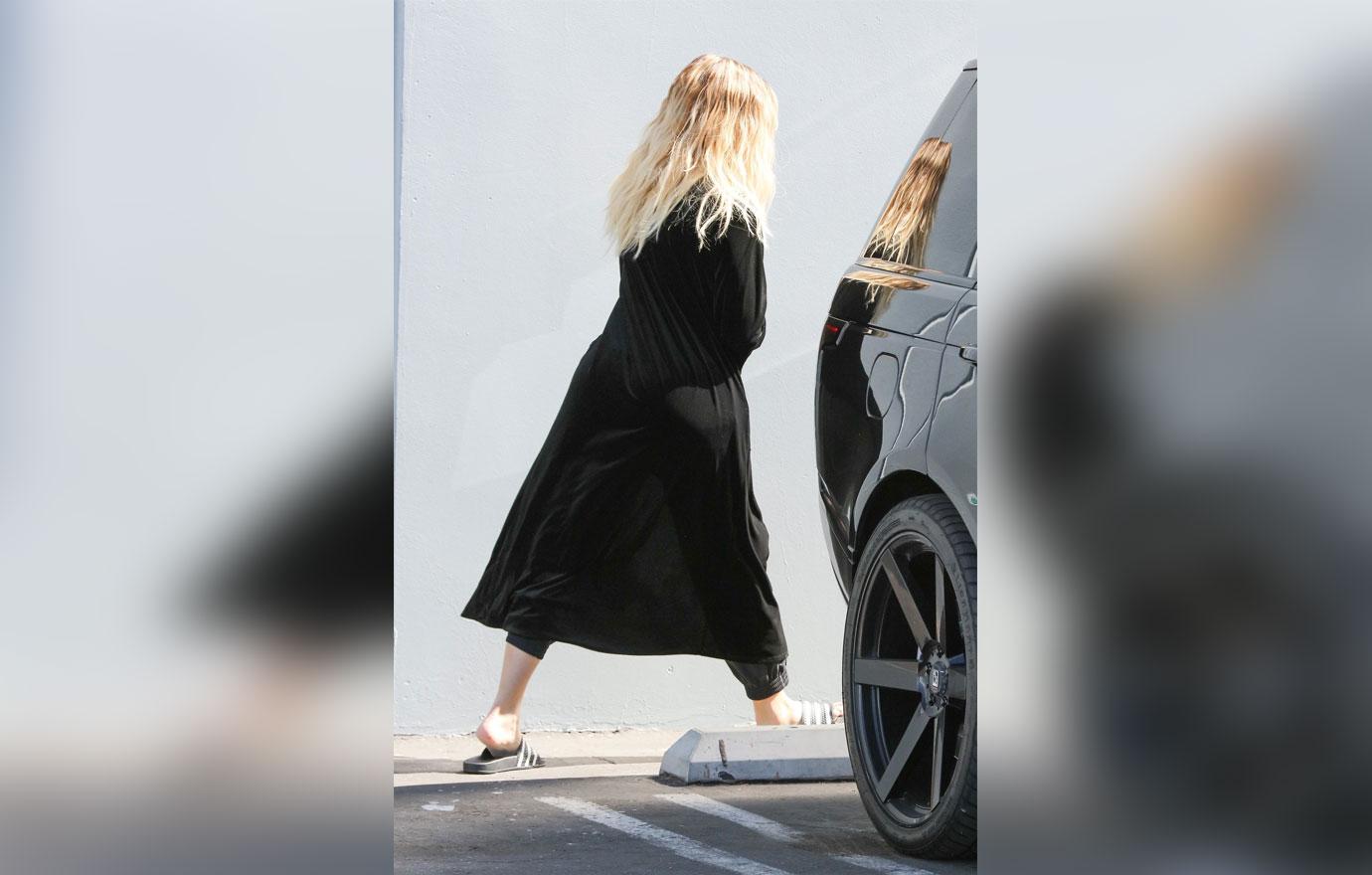 Khloe Kardashian covers baby bump