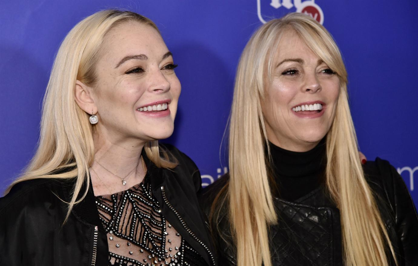 Lindsay Lohan wore a black leather jacket over a lacy black dress while her mother, Dina Lohan, sported a black leather jacket over a black turtleneck at a Hollywood event.