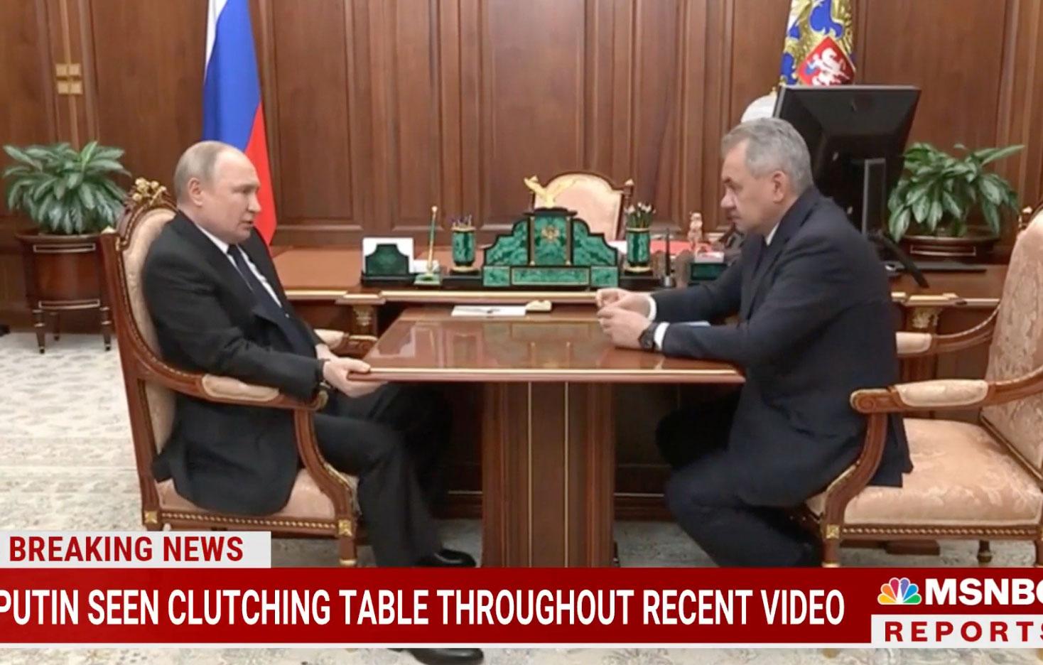 stone faced putin tightly grips table during kremlin meeting with the general as ailing health rumors swirl