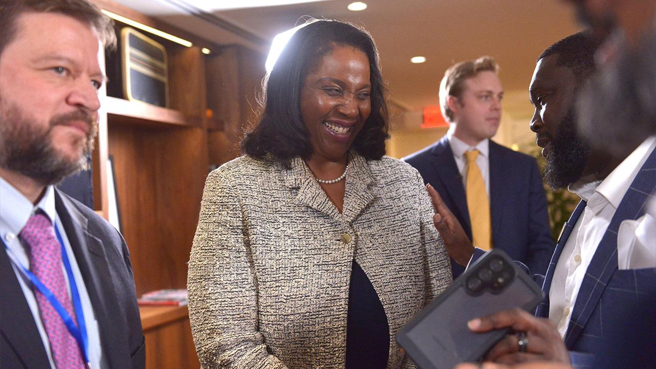 Lisa Cook smiling with attendees