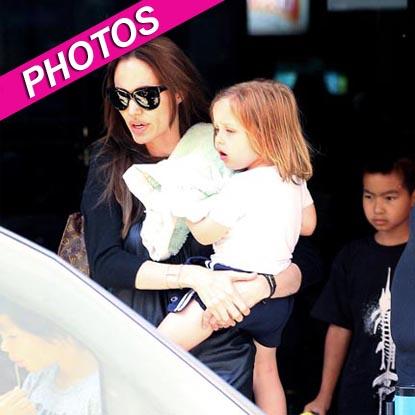 Angelina Jolie beams as she and kids Knox and Maddox arrive at JFK Airport