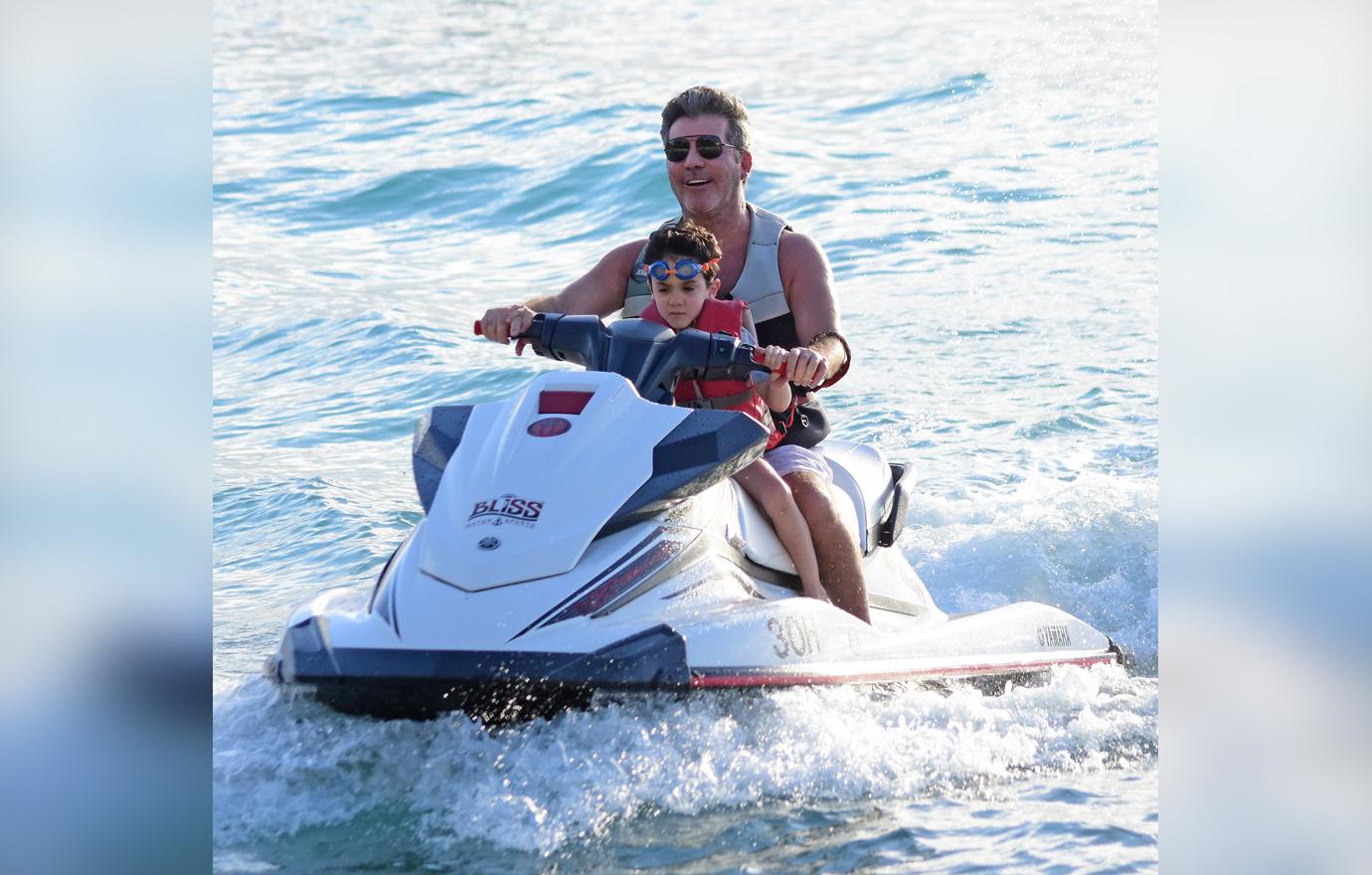 //simon cowell wears transformers mask on jet ski ride with son