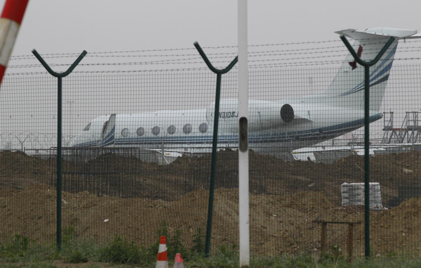 Jay Z’s private jet sits on the runway behind a metal fence at the Brussels Airport.