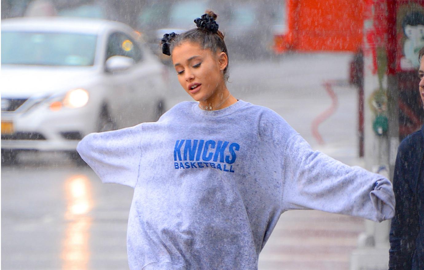 Ariana Grande skips alone and free in the rain