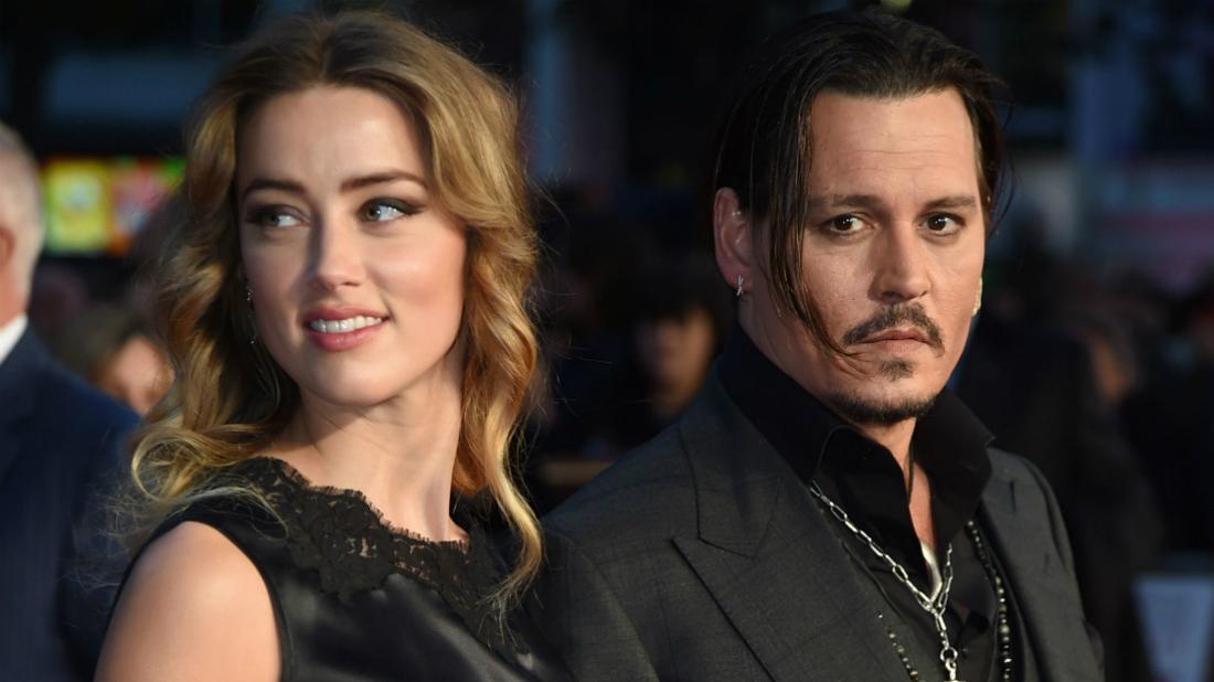 Amber Heard wore a lacy sleeveless gown next to Johnny Depp, who sported a tie-less black suit.