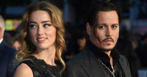Amber Heard wore a lacy sleeveless gown next to Johnny Depp, who sported a tie-less black suit.