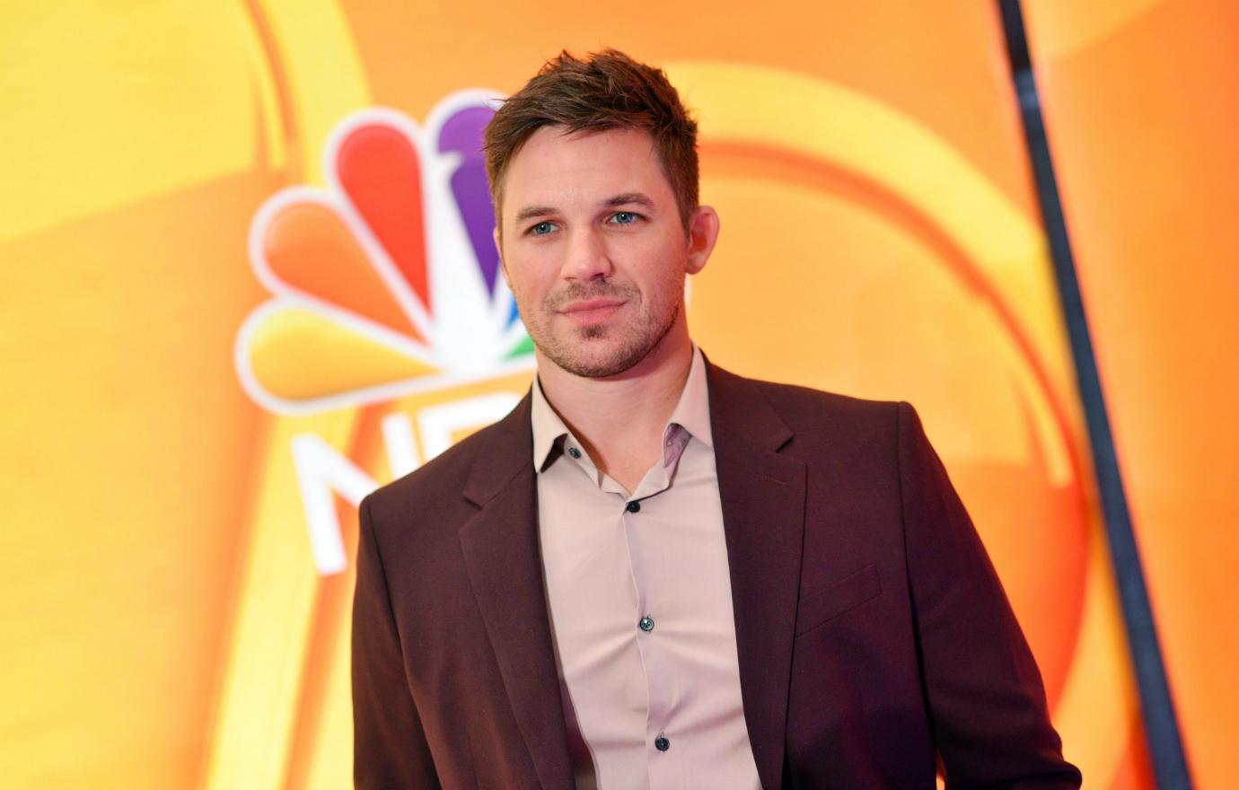 Matt Lanter wears a brown jacket and matching shirt on the red carpet.