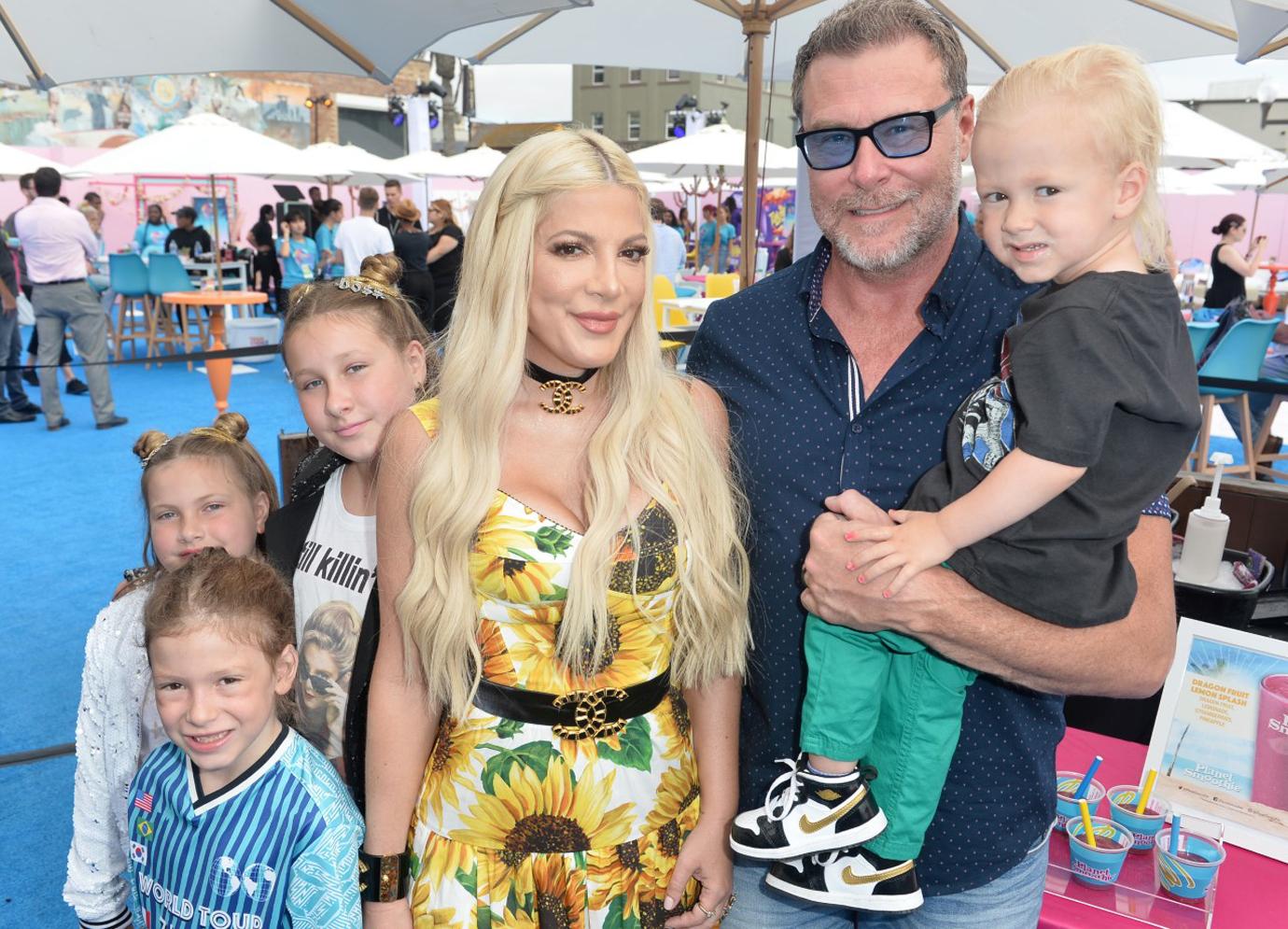 Tori Spelling in Sunflower Dress with Dean McDermott Smiling with Children