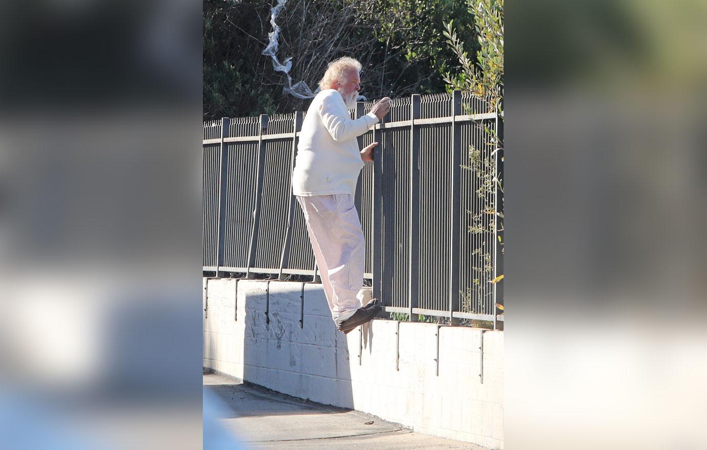 //Nick Nolte Climbs Fence Photos