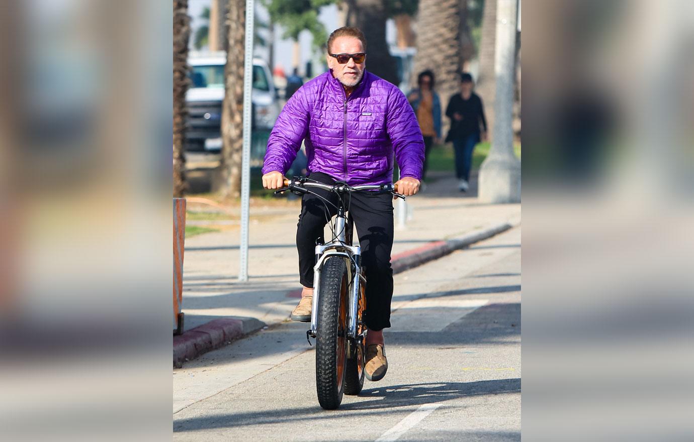 arnold schwarzenegger looking tense bike ride photos maria shriver divorce settlement final