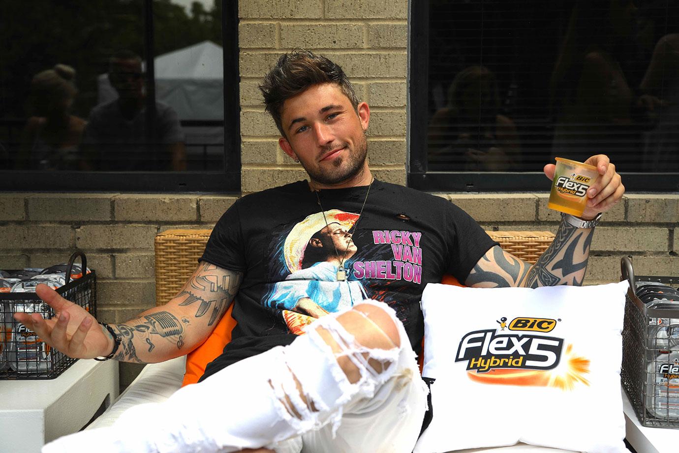 //Michael Ray enjoys a drink at the BIC Flex Hybrid Sip N Shave barbershop and lounge copy