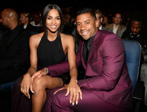 Ciara and Russel Wilson sit next to each other.