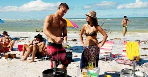 Channing Tatum stood shirtless in a pair of red shorts alongside Olivia Munn who wore a deep green bikini top and colorful sarong.