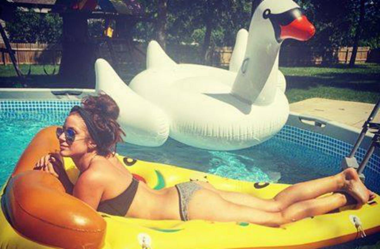 Chelsea Houska wears a bikini while laying on a pizza shaped pool float in this Facebook photo.