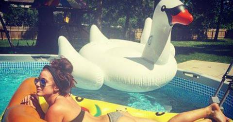Chelsea Houska wears a bikini while laying on a pizza shaped pool float in this Facebook photo.