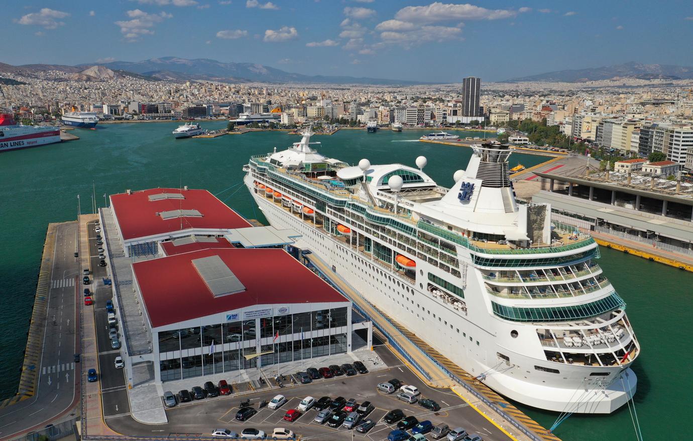 Rhapsody of the seas cruise ship liner crowded open sun deck with large pool and facilities docked in port of Piraeus