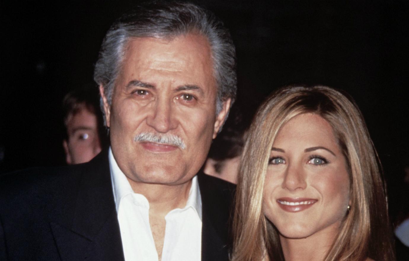 Jennifer Aniston wore a floral print dress while her father, John Aniston, wore a black blazer, white oxford and khaki pants.