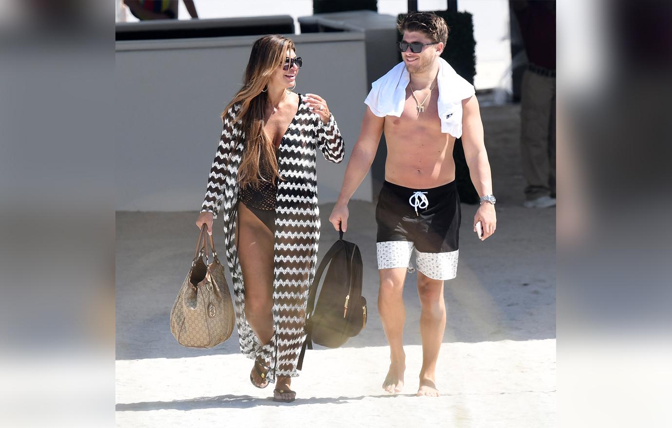 Teresa Giudice Walks Along The Beach With Blake Schreck Smiling Wearing Swimwear