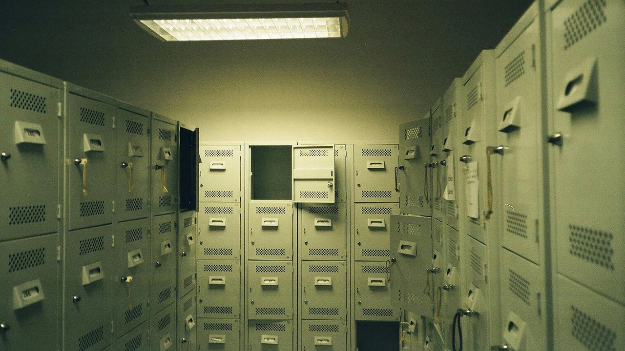Barker allegedly hid in the locker room's ceiling to commit voyeurism.