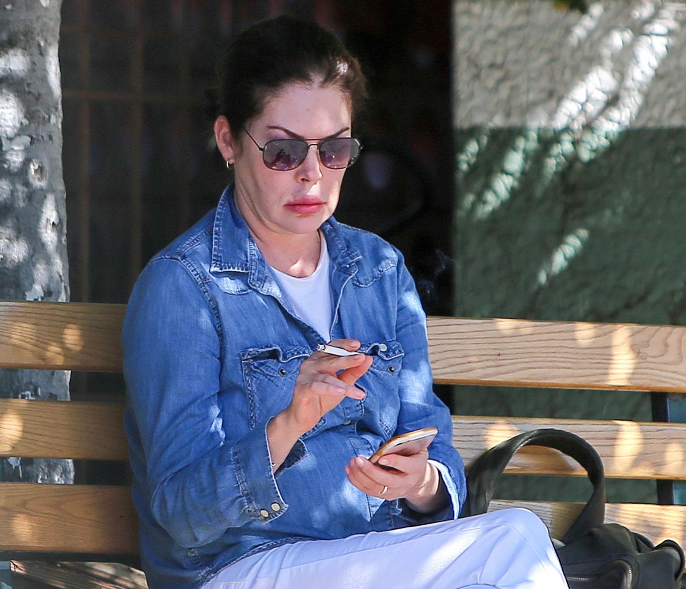 Lara Flynn Boyle Wearing Sunglasses, Denim Shirt, White T-Shirt and White Jeans