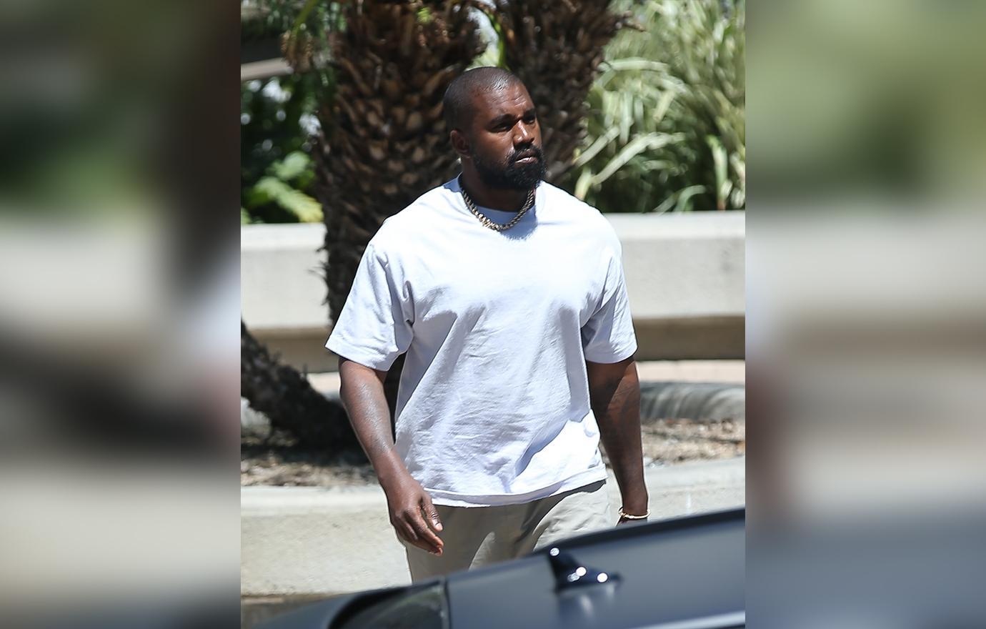 Kanye West carries a bag of fast food from his beloved McDonalds as he heads to a meeting in Calabasas.