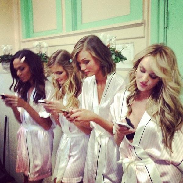 Victoria's Secret model Karlie Kloss texting with the other VS models, including Candice Swanepoel, backstage at he VS Fashion Show in a cute pic she shared. She says