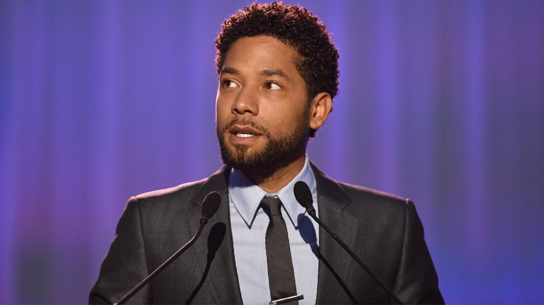 Jussie Smollet wears a gray shirt and black tie.