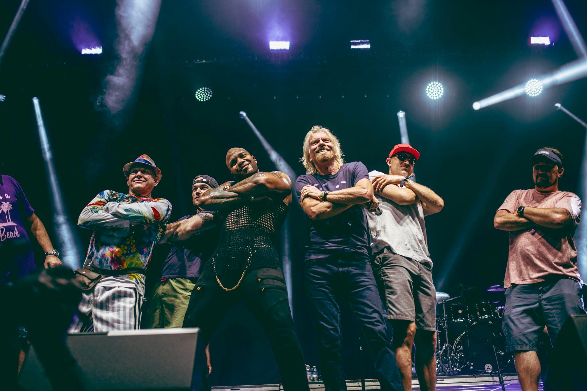 Sir Richard Branson (R) joins Flo Rida on stage during the sold out inaugural KAABOO Cayman Festival