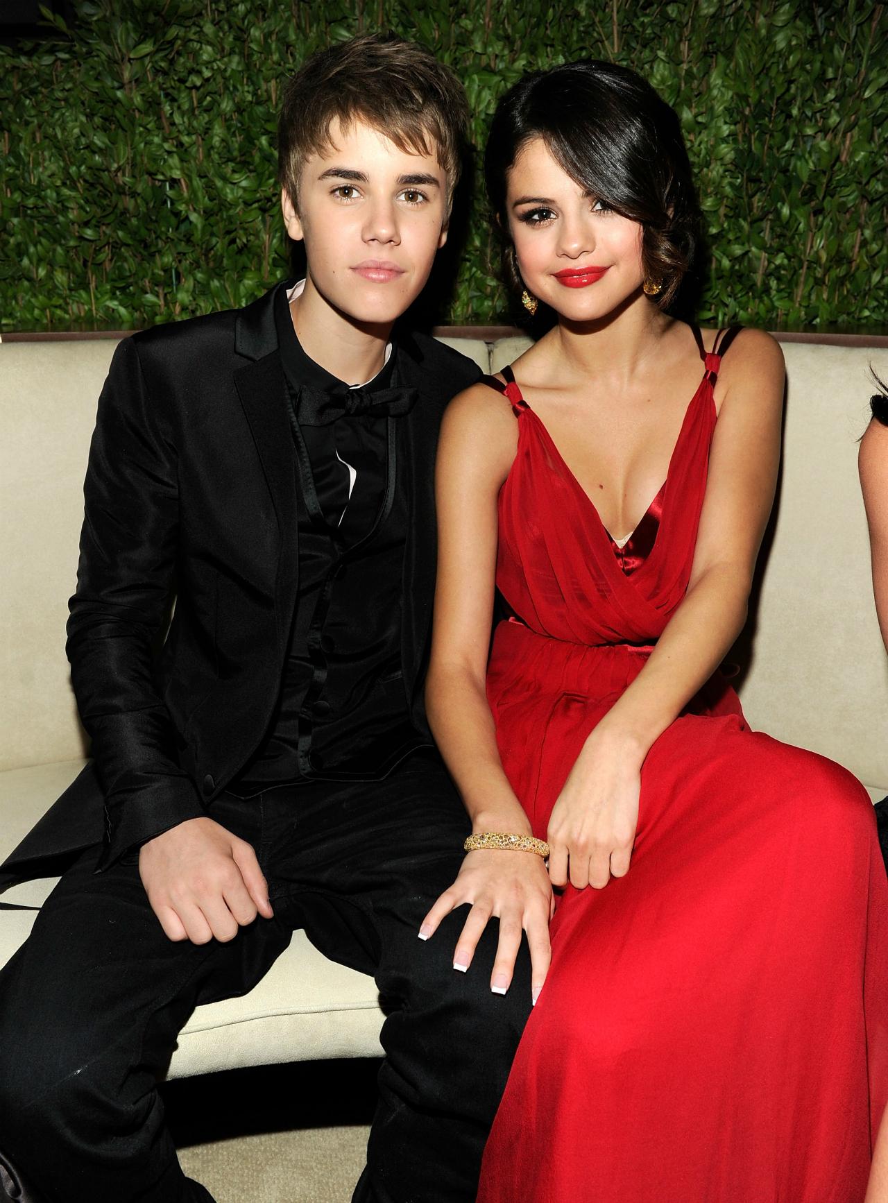 Selena Gomez attend the Vanity Fair Oscars party, with Gomez wearing a red dress and Bieber sporting a black tux.