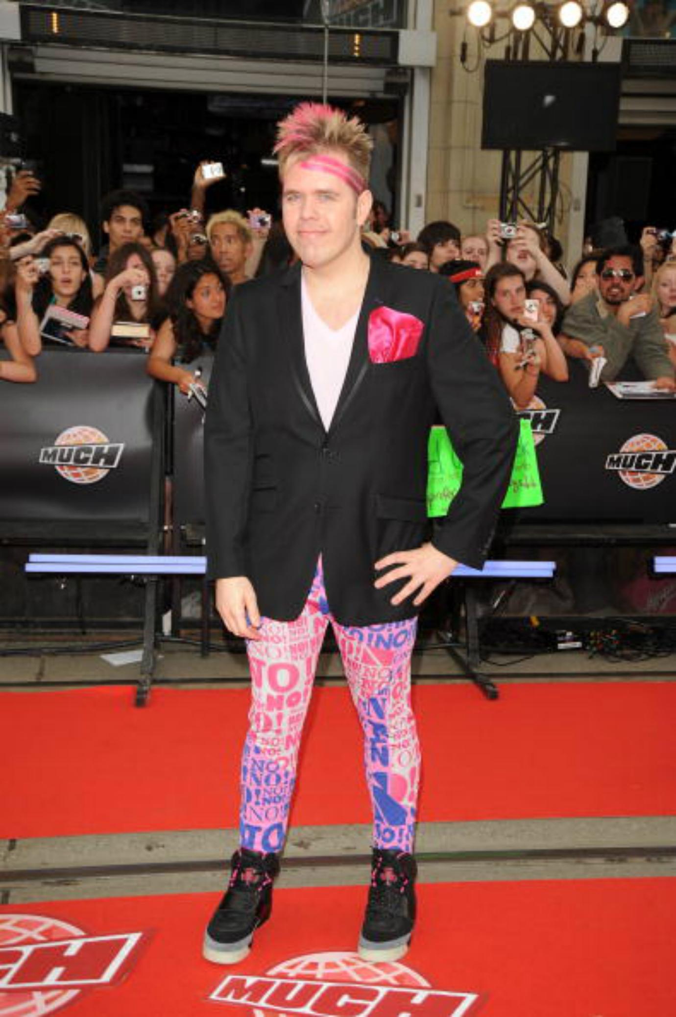 Perez Hilton poses on the red carpet.