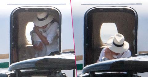 Meghan Markle cradles baby son Archie in both arms as she leaves the luxury private jet