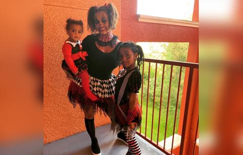 Briana Dejesus wears a creepy clown outfit with her kids.