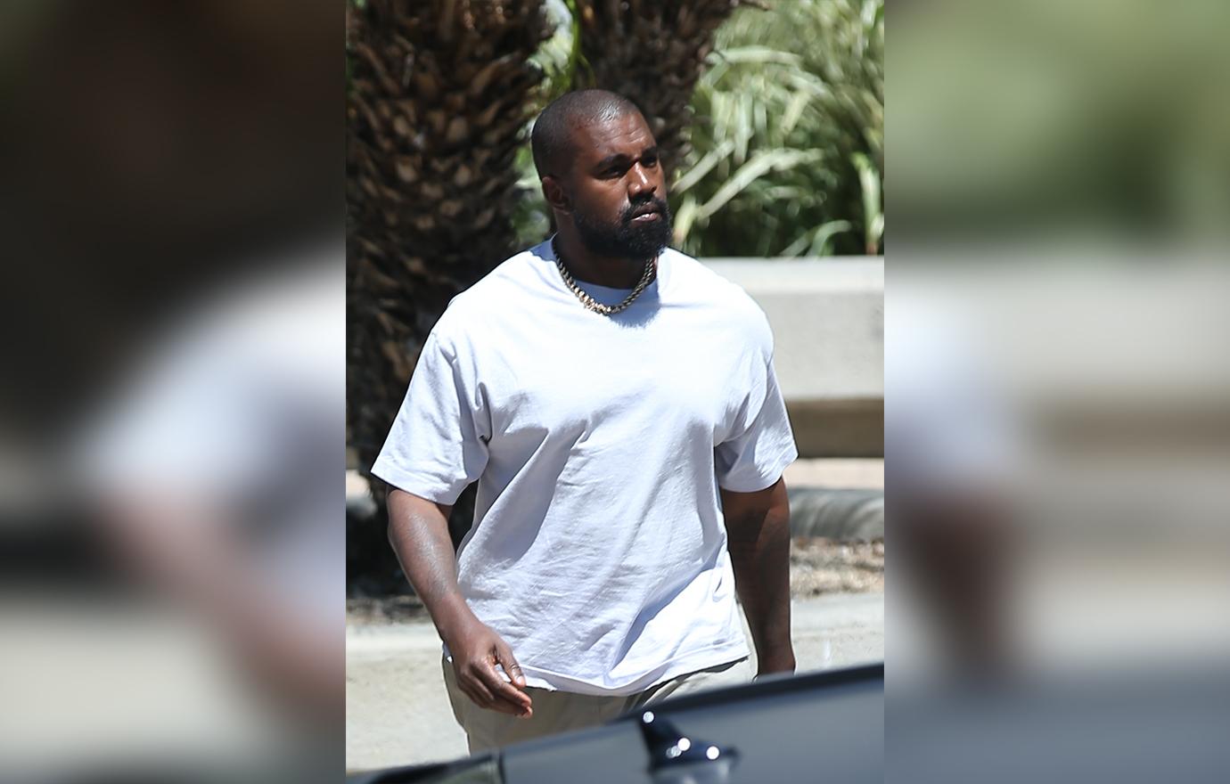 Kanye West carries a bag of fast food from his beloved McDonalds as he heads to a meeting in Calabasas.