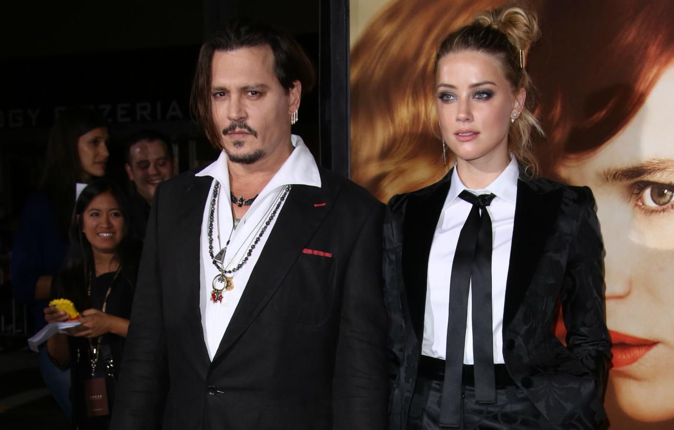 Johnny Depp looked like a deer in headlights, while he sported a black suit without a tie, but accessorized with three necklaces while Heard looked miserable in a black embroidered matching pants and blazer.