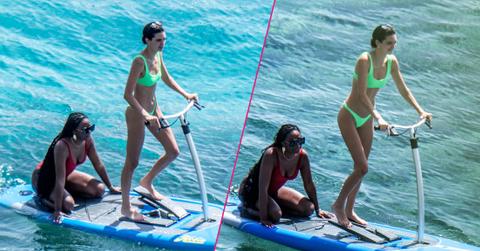 Kendall Jenner wears a neon-green bikini while having fun with friends paddle boarding in Mykonos.