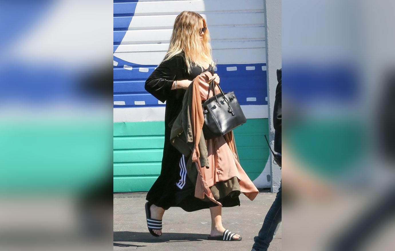 Khloe Kardashian covers baby bump