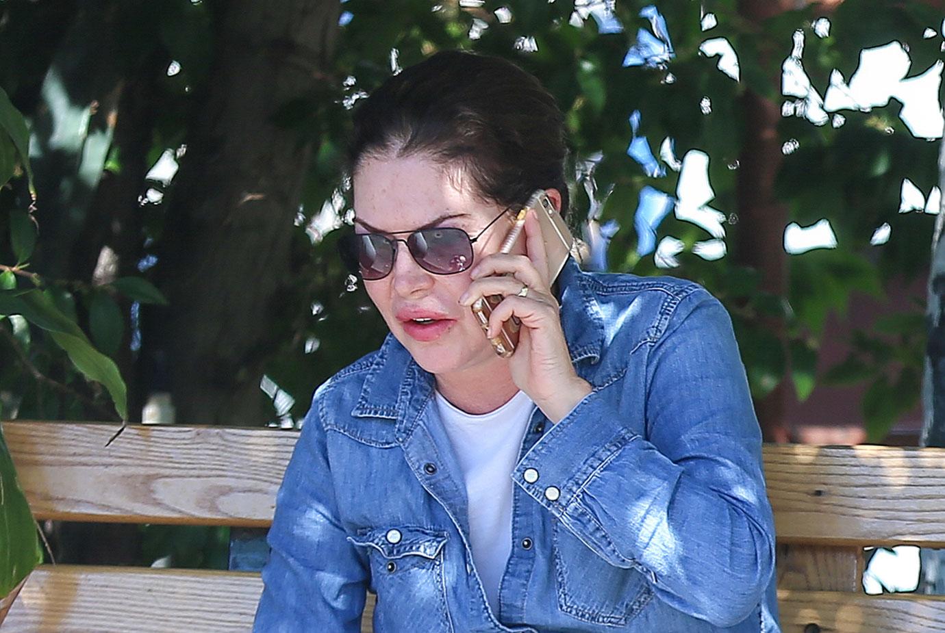 Lara Flynn Boyle Wearing Sunglasses, Denim Shirt, White T-Shirt and White Jeans