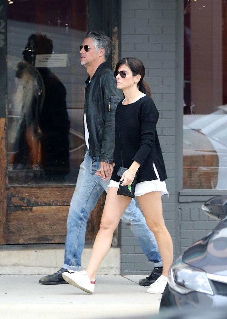 //sandra bullock bryan randall move in date holding hands