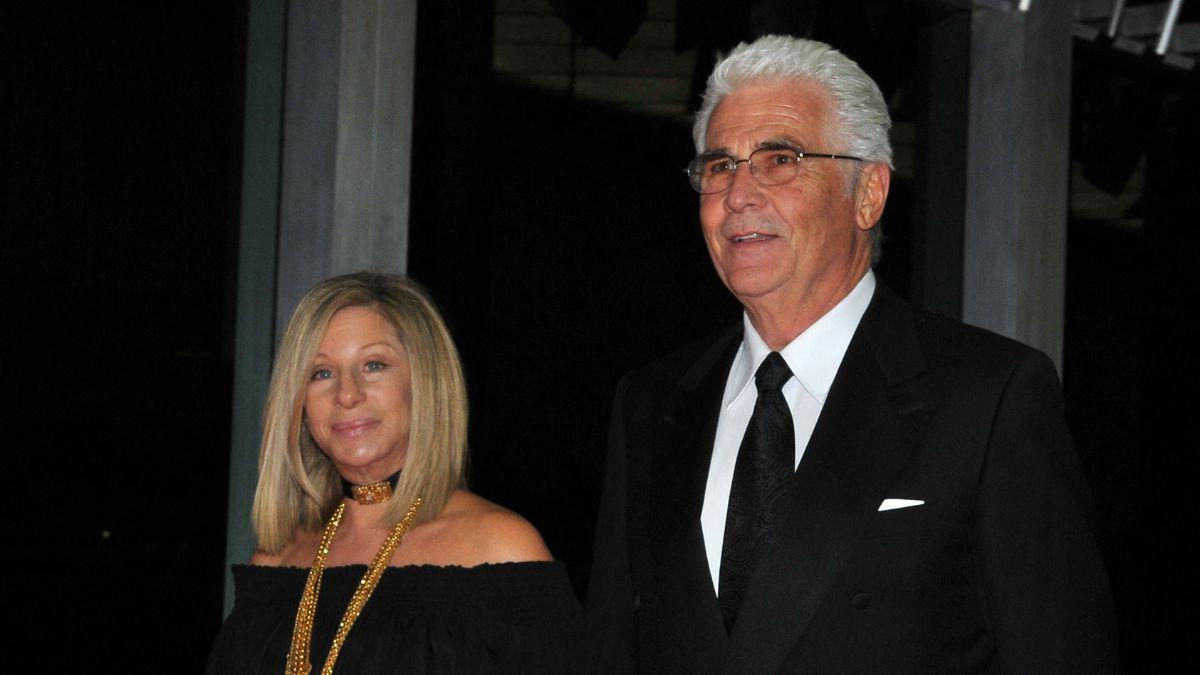 A source said Barbra Streisand 'can't keep her hands off' her husband.