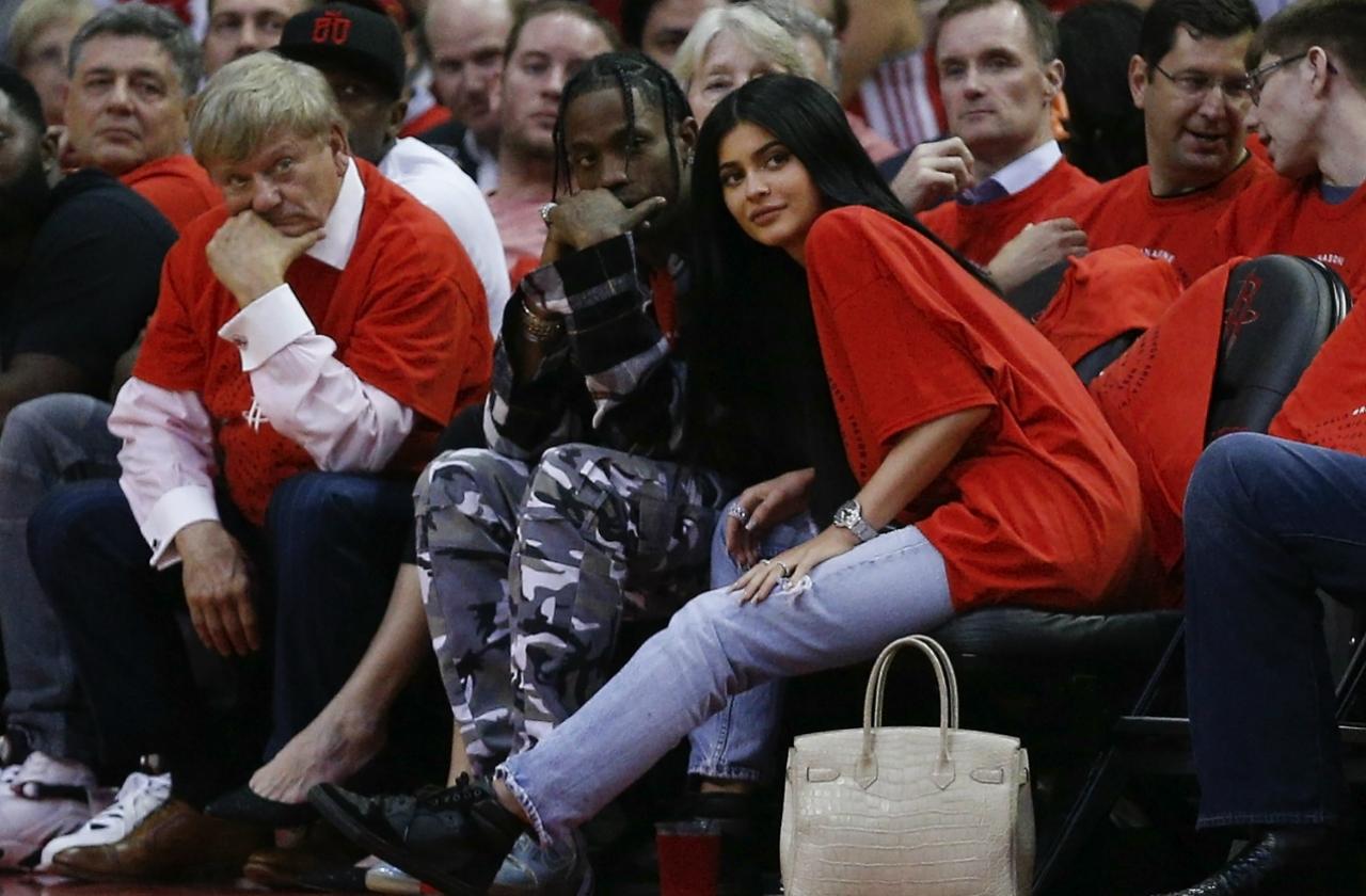 Travis Scott and Kylie Jenner courtside basketball game in red shirts