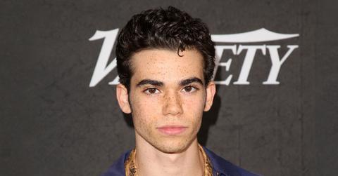 Cameron Boyce Closeup With Serious Expression Wearing Navy Jacket and Yellow Shirt
