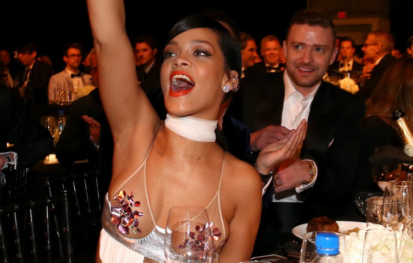 Rihanna, wearing a Tom Ford dress and pasties, gave the designer a cheer as a tuxedo-clad Justin Timberlake looks on behind her.