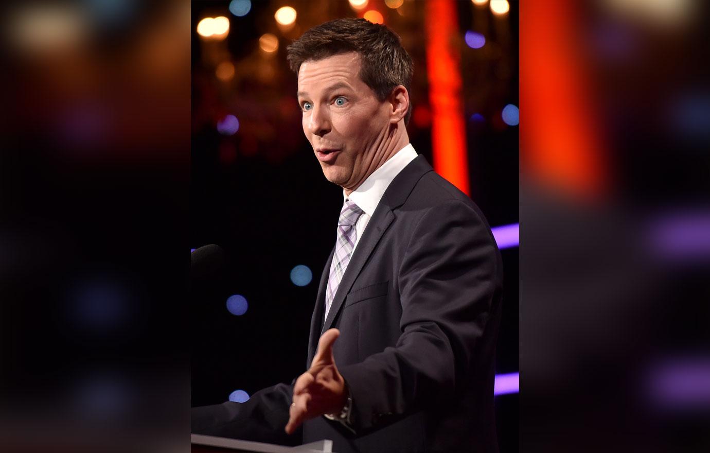 Sean Hayes Wearing a Suit and Tie on Stage Making A Surprised Face