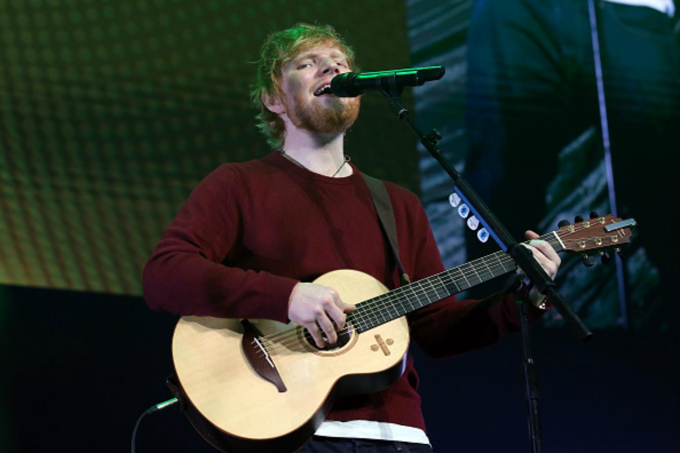 Ed Sheeran performs on stage.