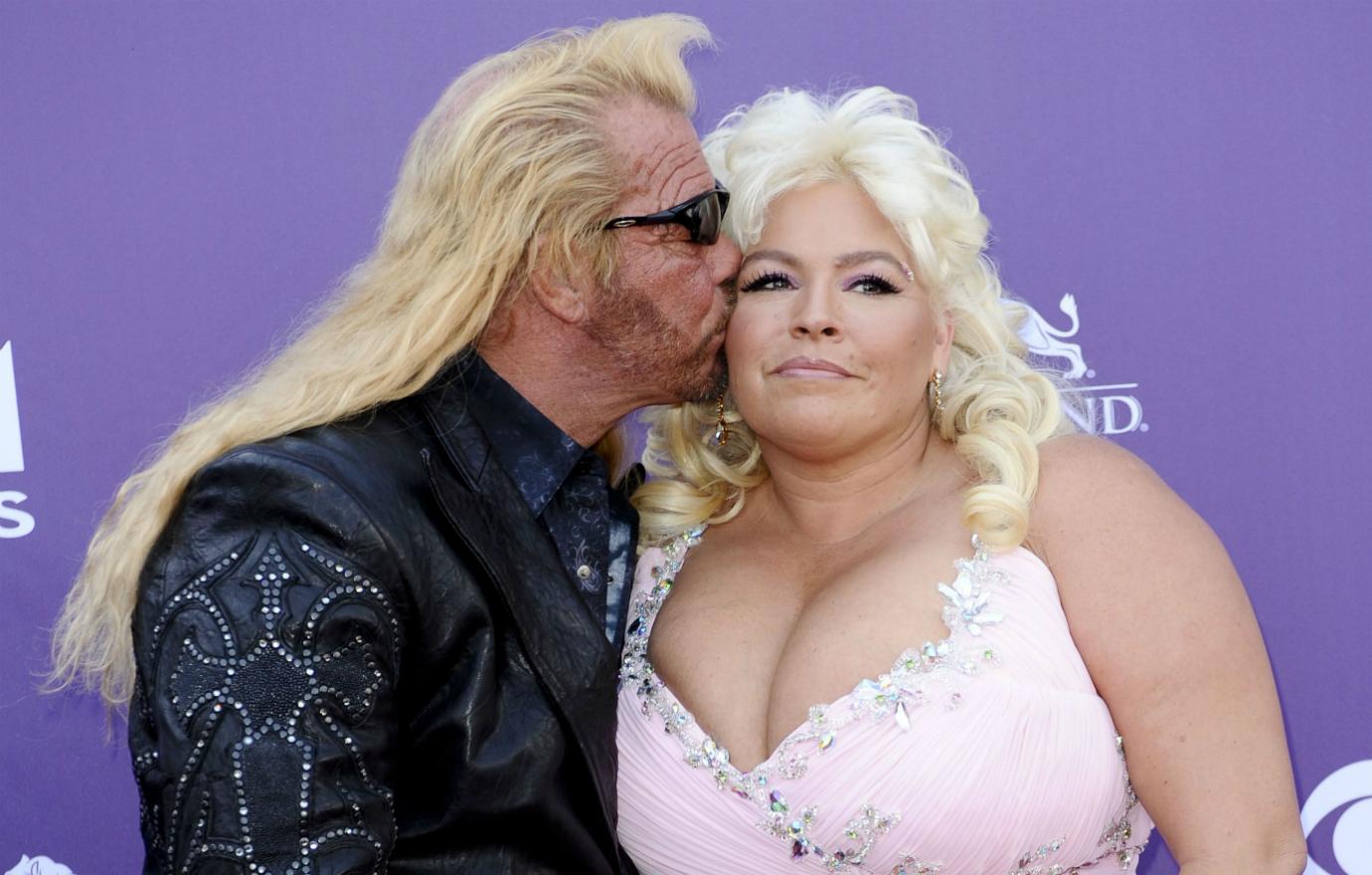 Dog the Bounty Hunter wore a black leather studded jacket over a black dress shirt and slacks while his wife, Beth Chapman, donned a pink flowing dress.