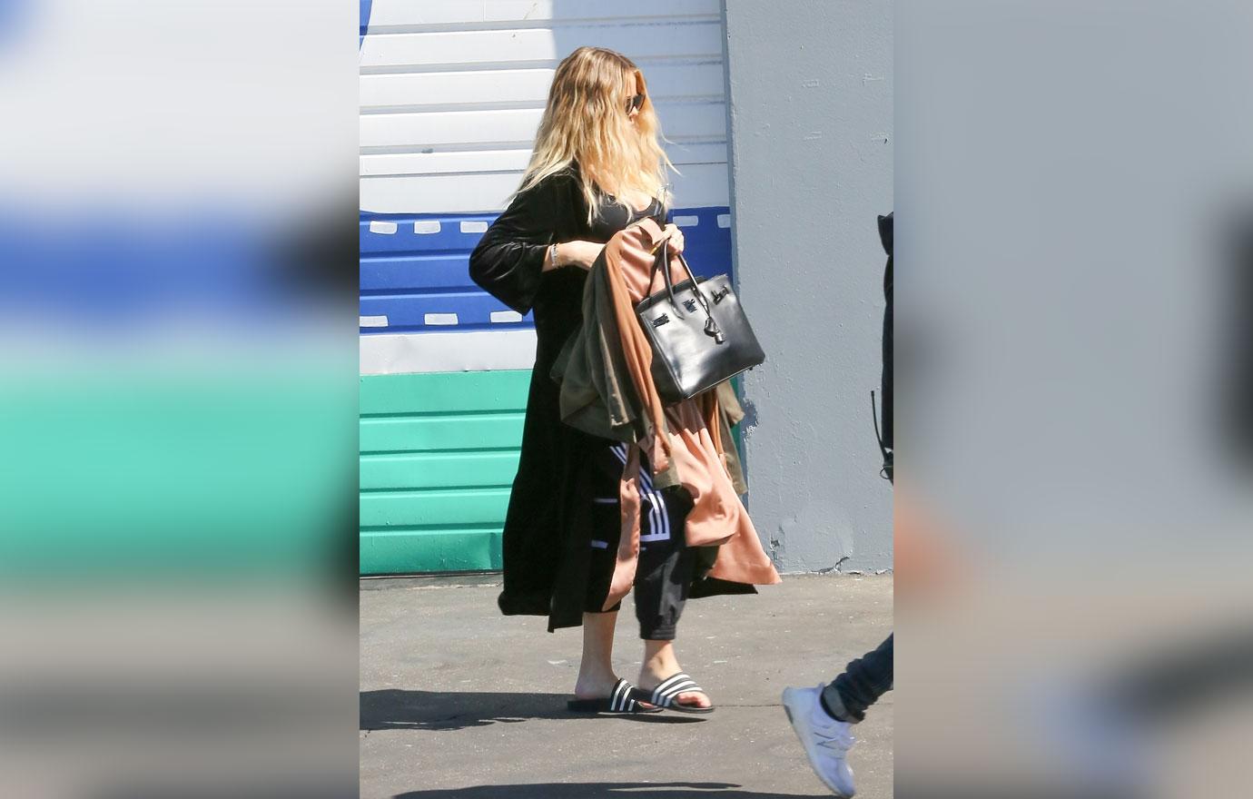 Khloe Kardashian covers baby bump