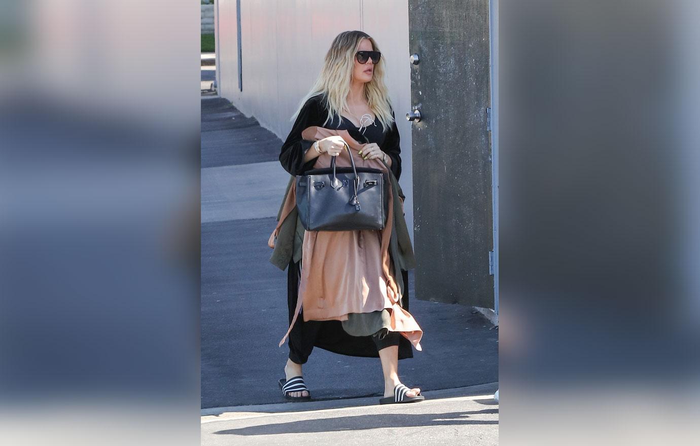 Khloe Kardashian covers baby bump